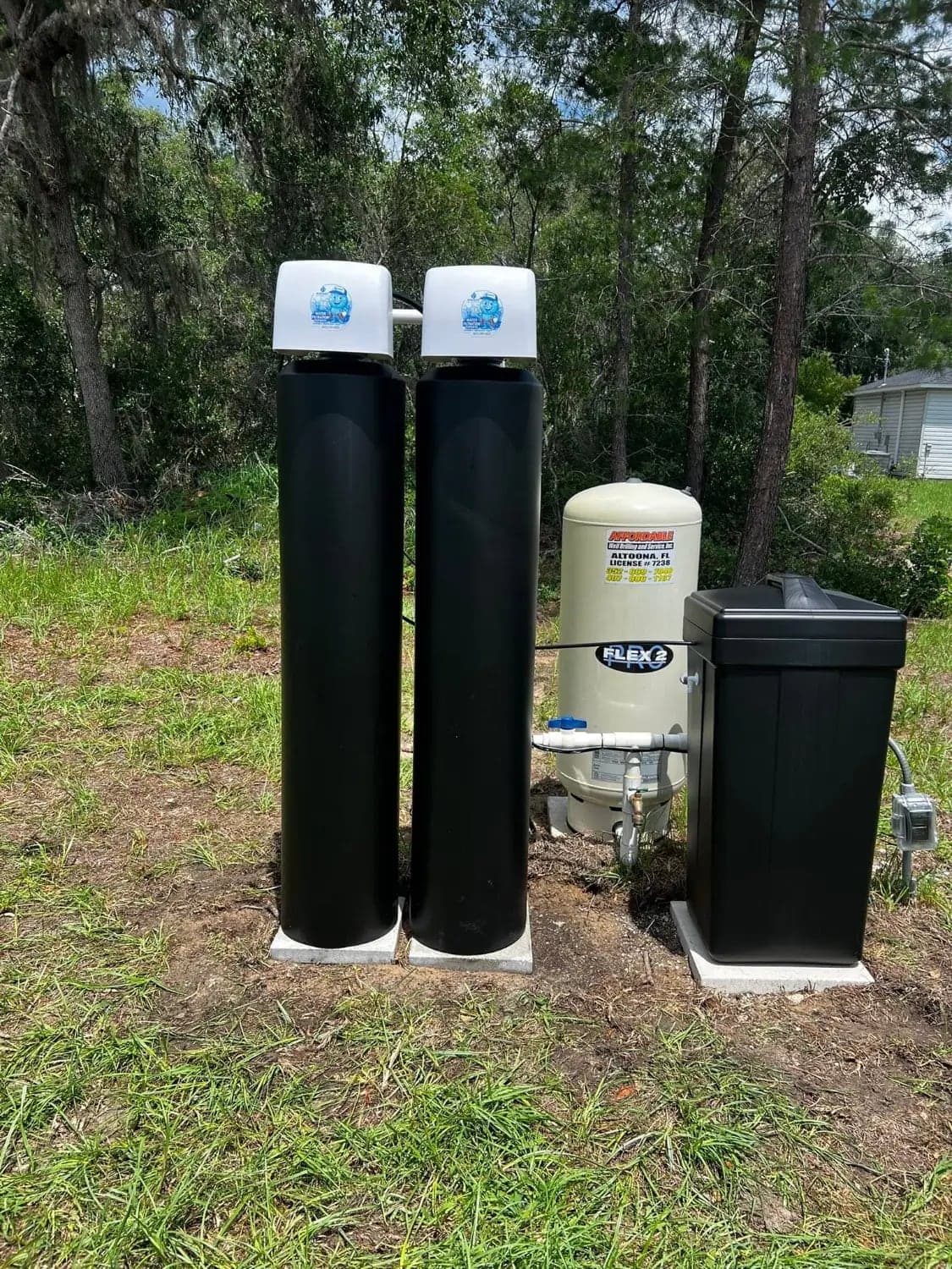 Complete well water treatment system with softener tanks, brine tank and pressure tank